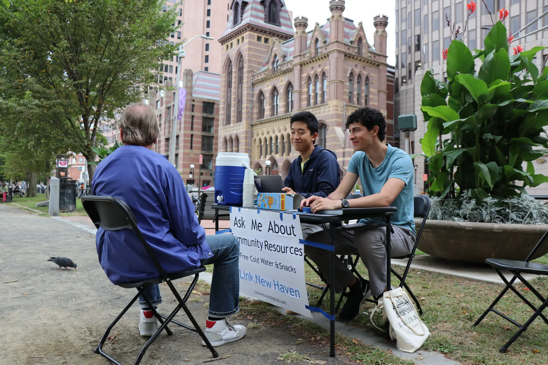 Link New Haven volunteers at a community resource desk on the New Haven Green